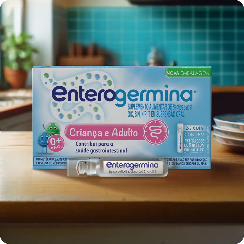 Enterogermina Criança e Adulto, 10 frascos de 5 ml, suspensão probiótica em uma superfície de madeira.